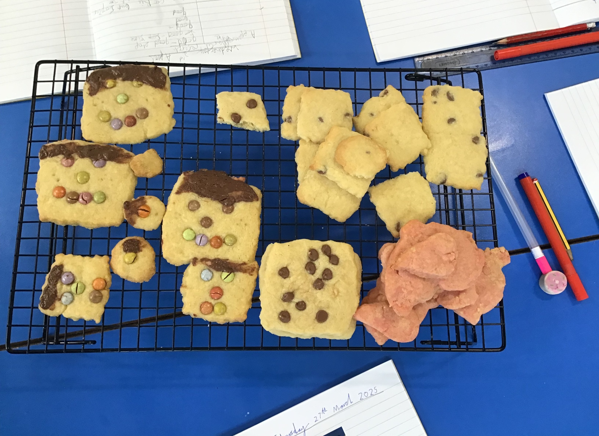 Selection of decorated biscuits displayed on wire cooling tray