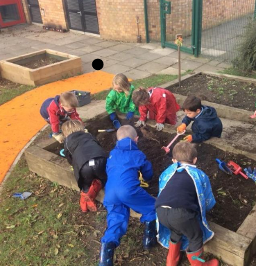 Children digging in planting beds