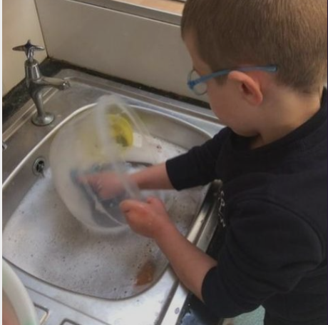 Child washing up a bowl