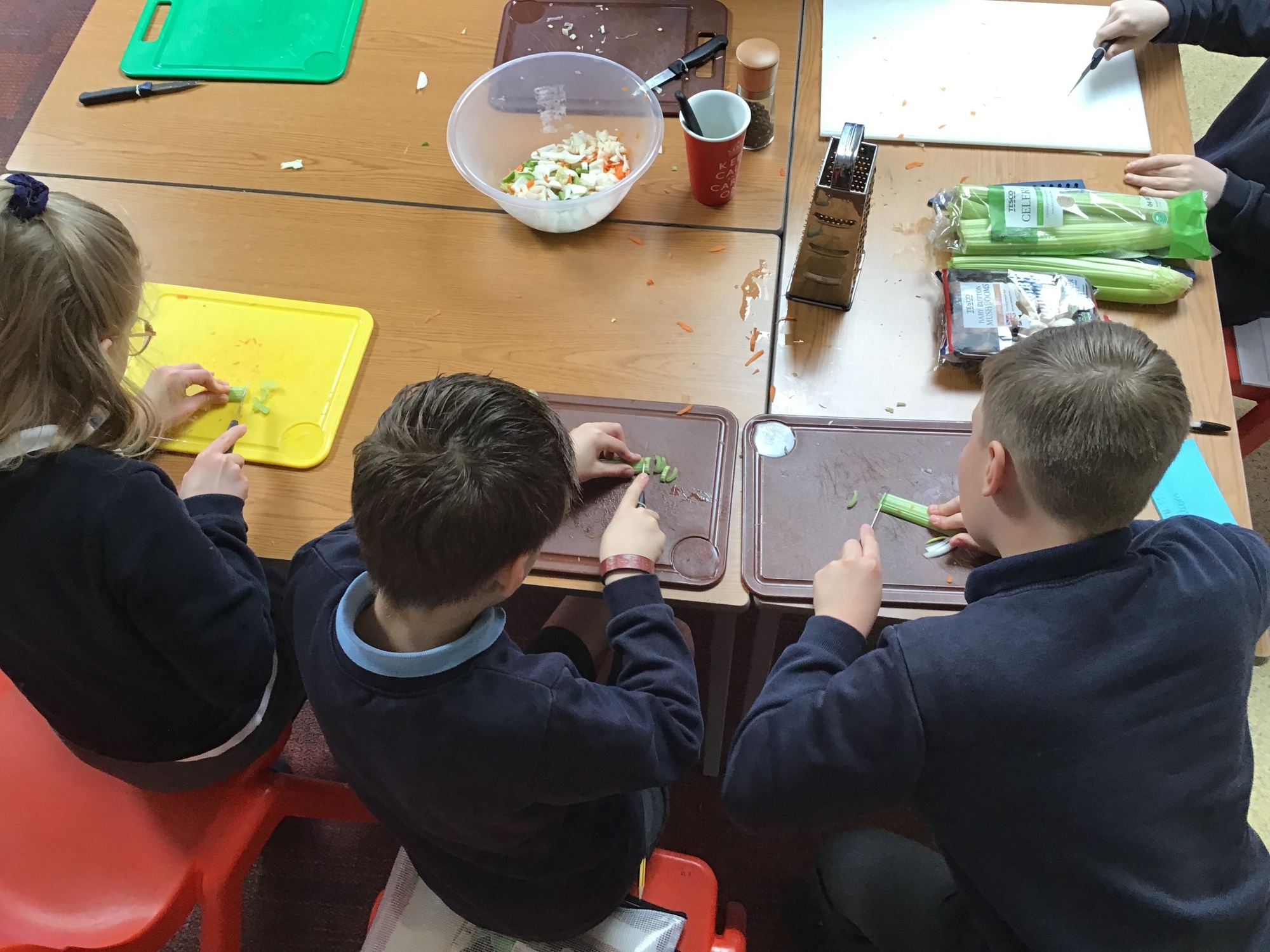 Children chopping up celery