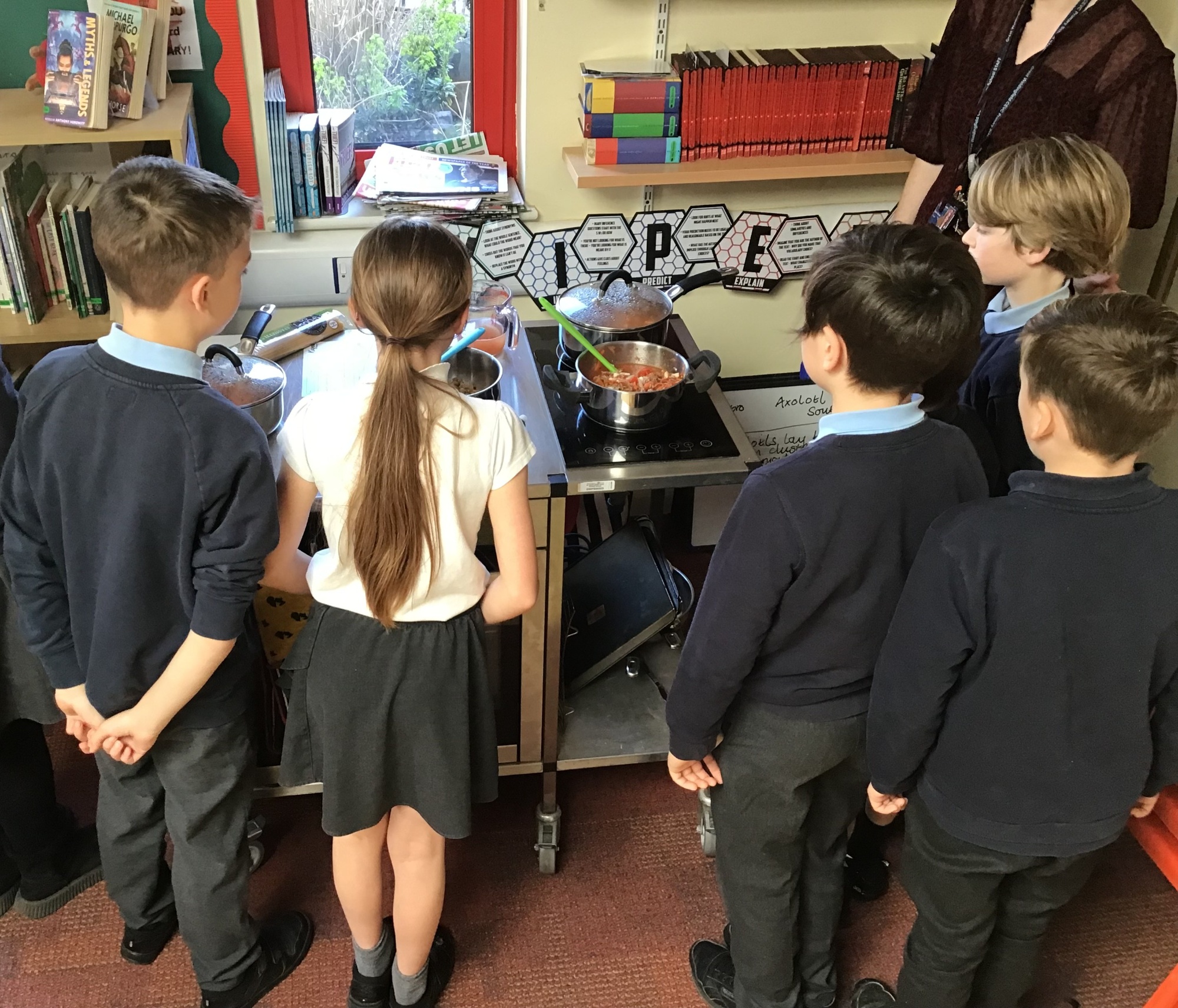 Children watching their bolognese sauce cooking